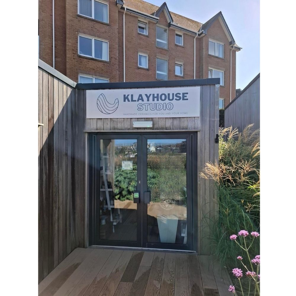 exterior of KLAYHOUSE Studio with handmade ceramics displayed on shelves
